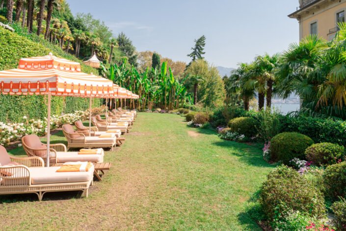 The peaceful garden and lounging area of Grand Hotel Tremezzo overlooking Lake Como, a tranquil oasis for relaxation