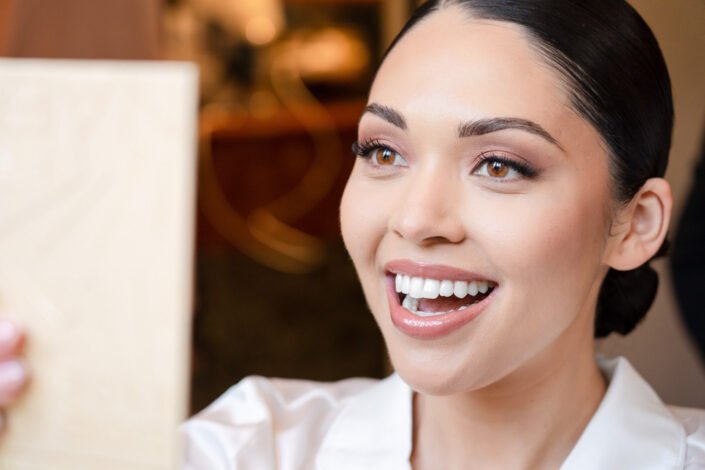 A radiant bride-to-be, glowing with joy during her makeup session before the wedding