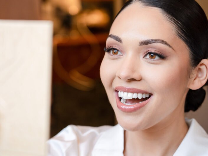 A radiant bride-to-be, glowing with joy during her makeup session before the wedding